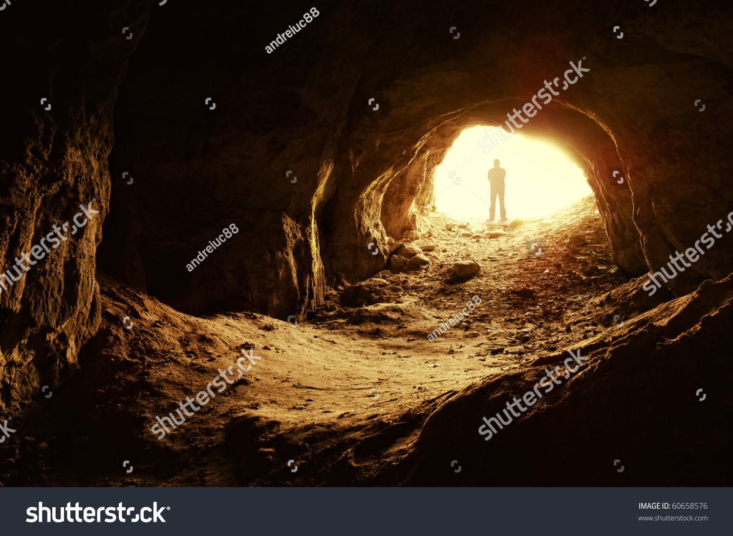 Man Standing In Front Of A Cave Entrance Stock Photo 60658576 