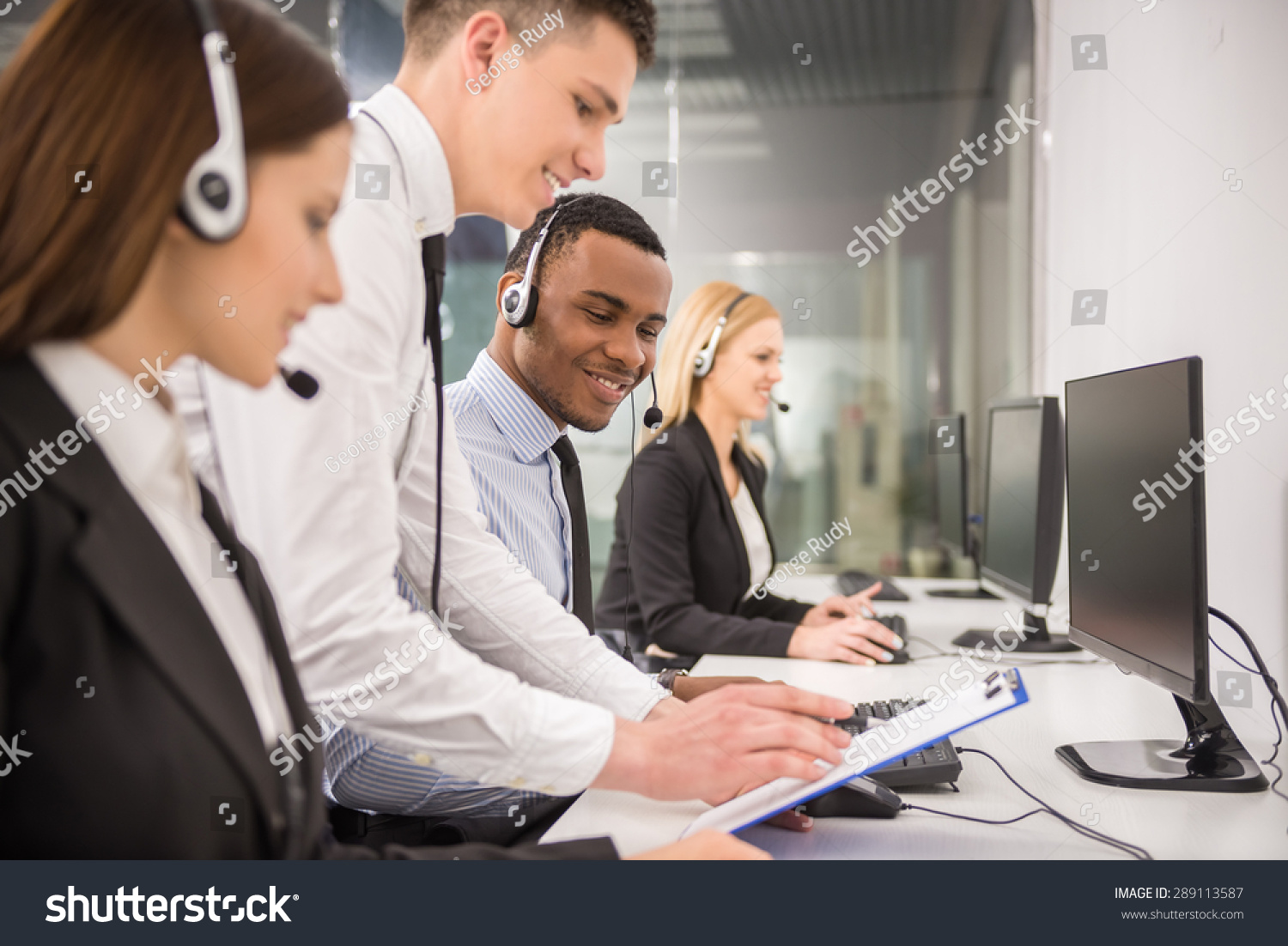 manager-explaining-something-to-his-employee-in-a-call-centre-stock