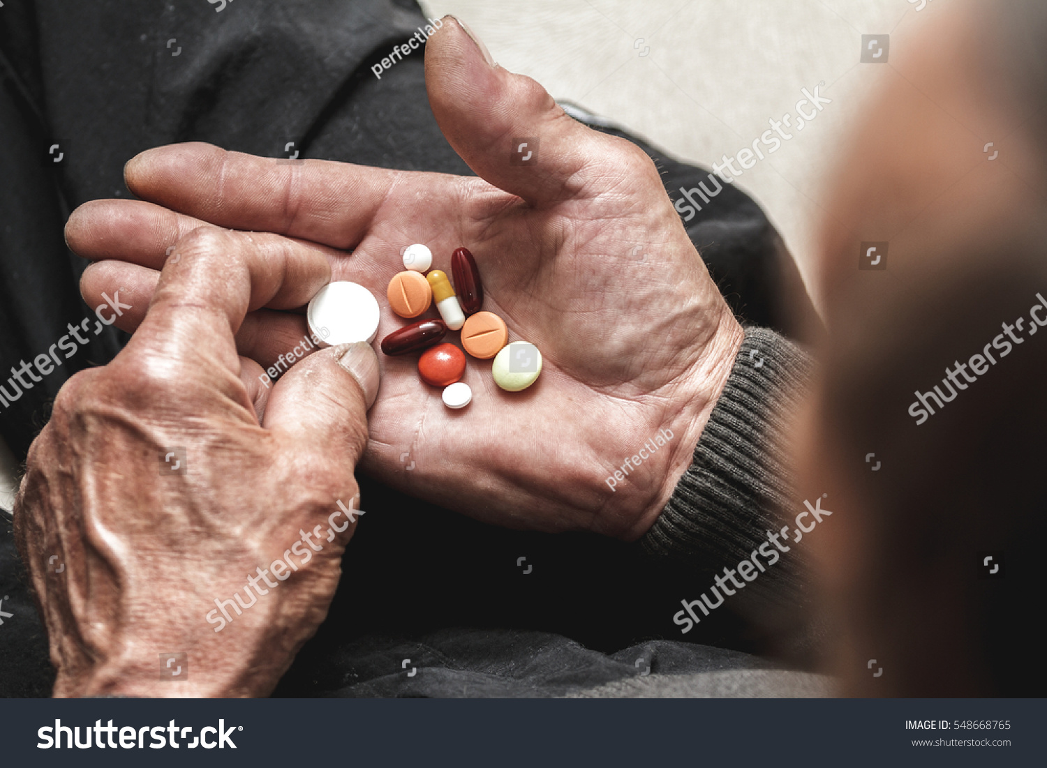 Many multi-colored pills in a Senior's hands Painful old age Caring for the health of the elderly Many multi-colored pills in a Senior's hands Painful old age Caring for the health of the elderly