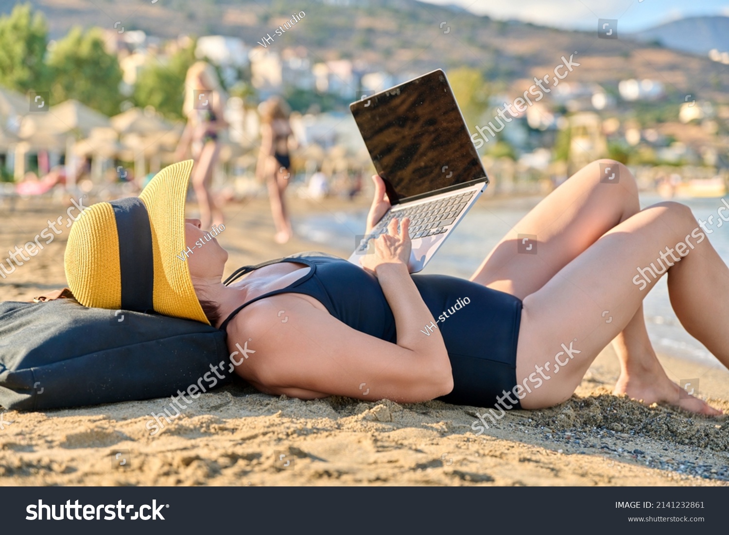 Mature Woman Sunbathing On Beach Using库存照片 Shutterstock