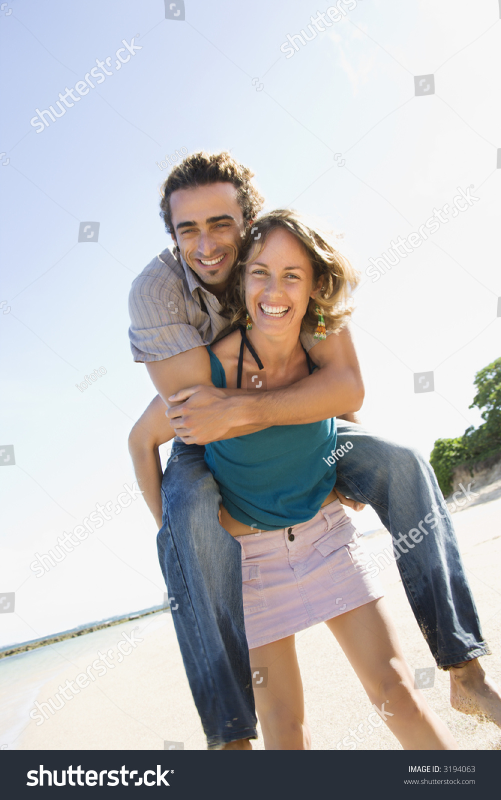 Midadult Caucasian Woman Giving Man Piggyback Stock Photo