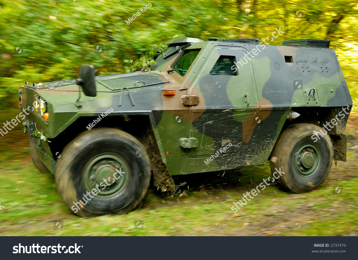 Military OffRoad Vehicle Driving On A Forest Dirt Road, Ripping Leaves