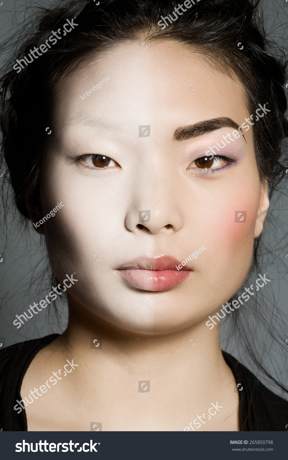 Model with one half of her face pale, and another half made up. - stock-photo-model-with-one-half-of-her-face-pale-and-another-half-made-up-265850798