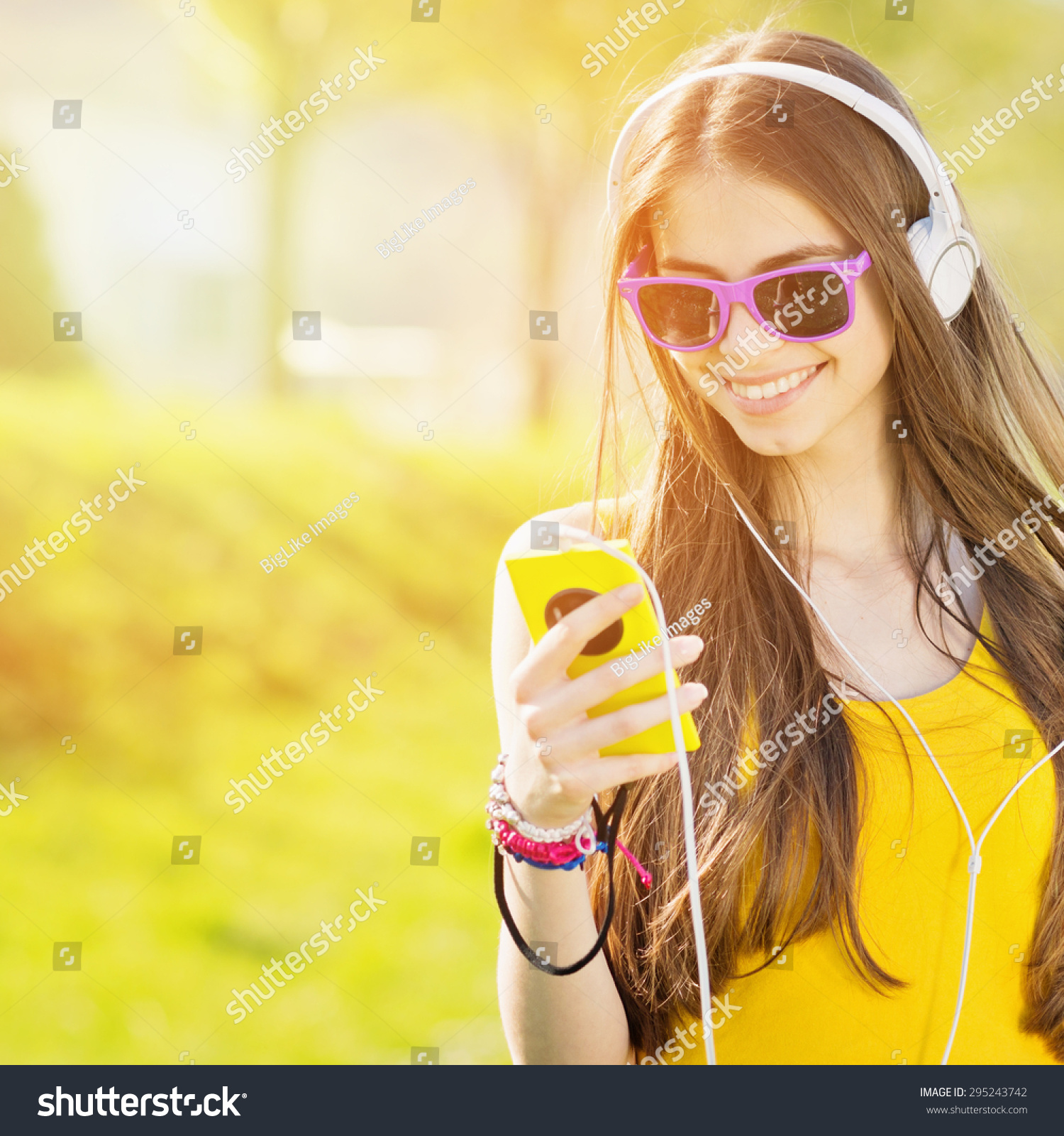 Modern Happy Millennial Teenage Girl With Sunglasses Headphones And Smartphone Smiling Standing 7813