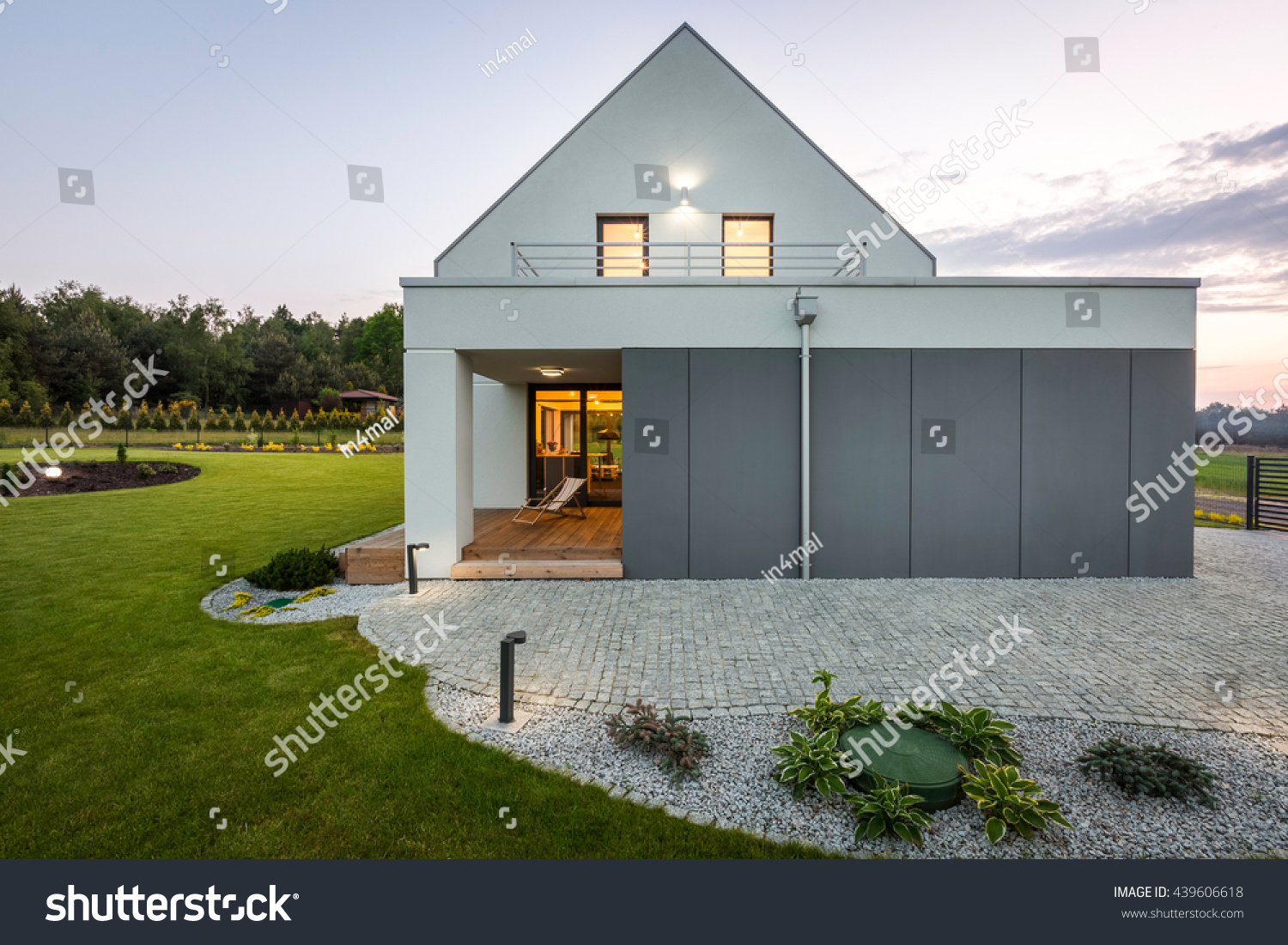 Modern villa with garage stone driveway backyard and decorative outdoor lighting Modern villa with garage stone driveway backyard and decorative outdoor lighting