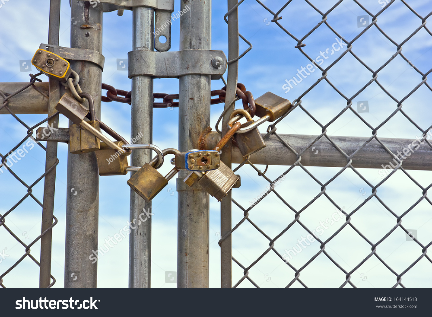 Multiple Padlocks Used On A Chain Link Fence Help Keep It Lock And