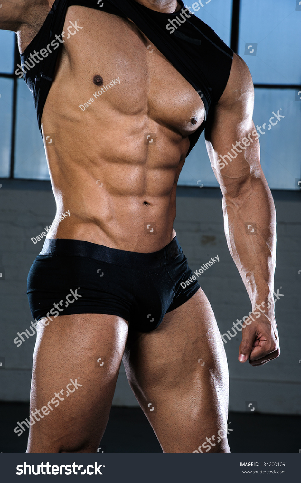 Male Fitness Model Standing On Black Stock Photo 554790091 
