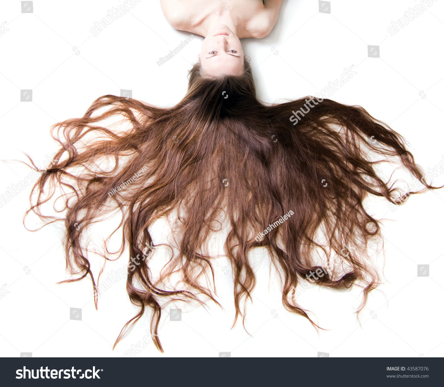 Naked Woman With A Long Brown Hair On A White Background Stock Photo