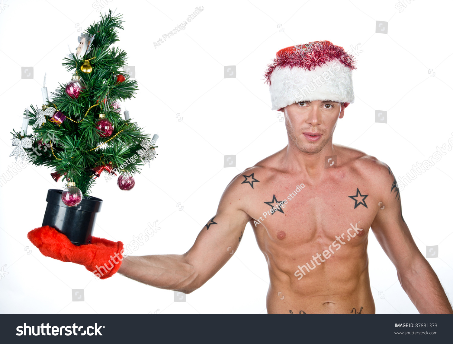 Naked Young Guy Dressed As Santa Claus With Christmas Tree In His Hand