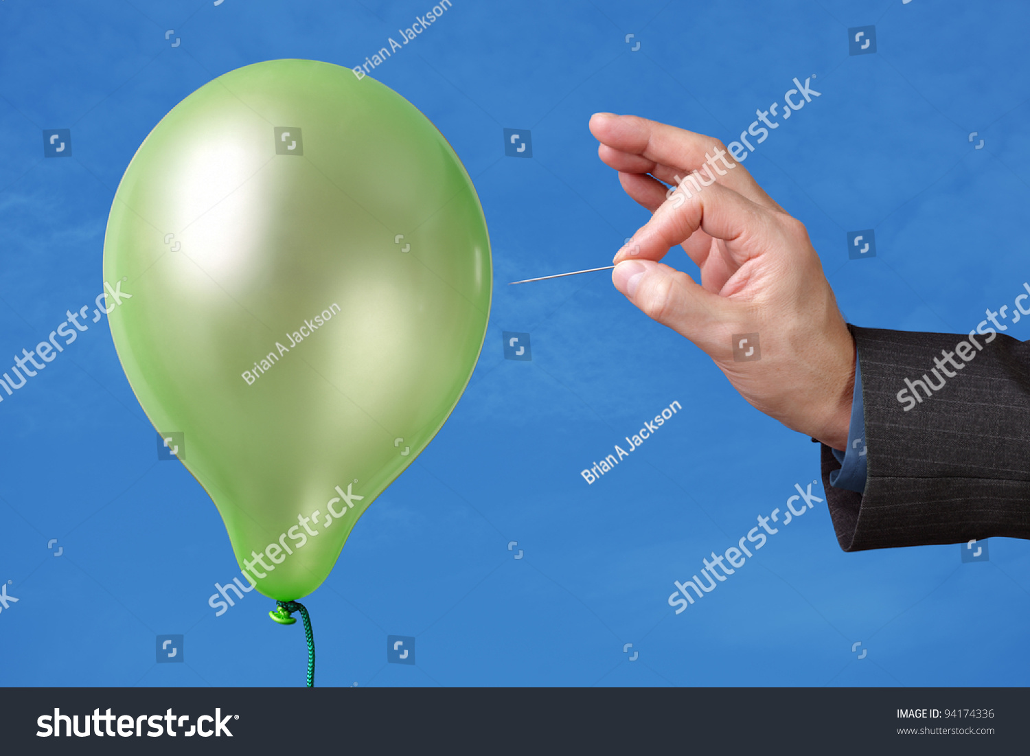 stock-photo-needle-about-to-pop-a-green-