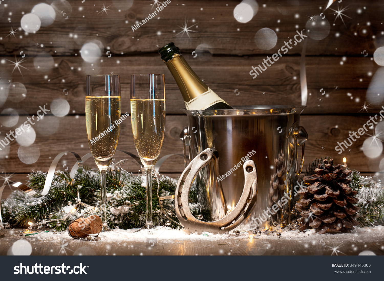 New Years Eve celebration background with pair of flutes and bottle of champagne in bucket and a horseshoe as lucky charm New Years Eve celebration background with pair of flutes and bottle of champagne in bucket and a horseshoe as lucky charm