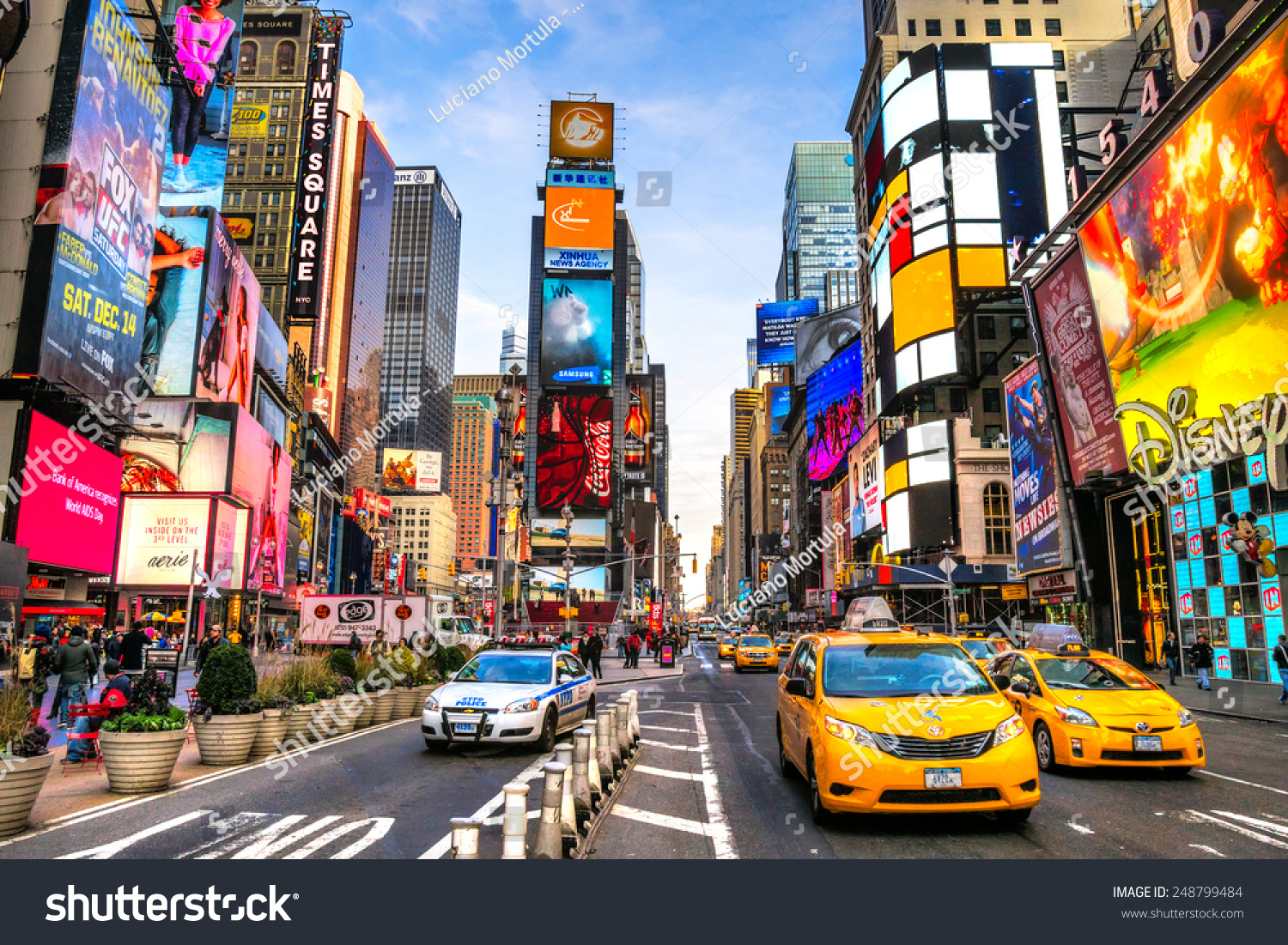 stock-photo-new-york-city-dec-times-square-is-a-busy-tourist-intersection-of-neon-art-and-commerce-and-is-248799484.jpg