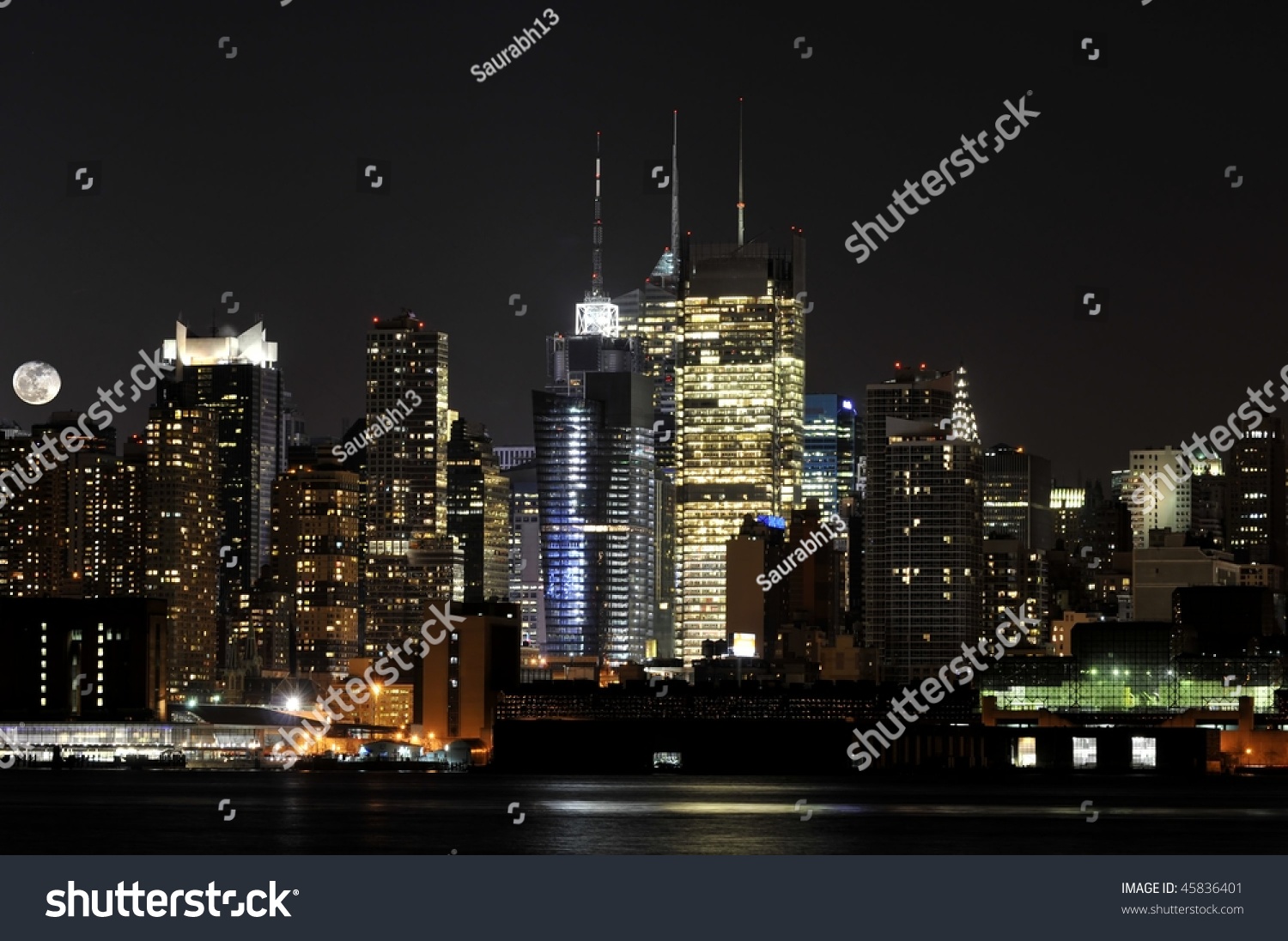 New York City Skyline With A Rising Moon New York City Skyline With A Rising Moon Stock Photo