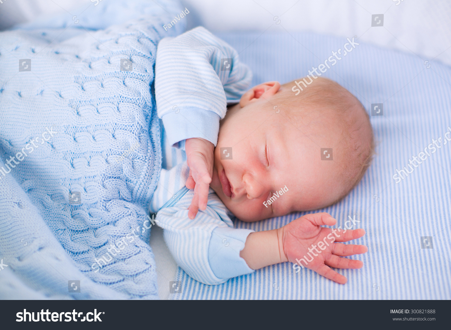 Small Baby Sleeping Under A Colorful Blanket Stock Photo ...