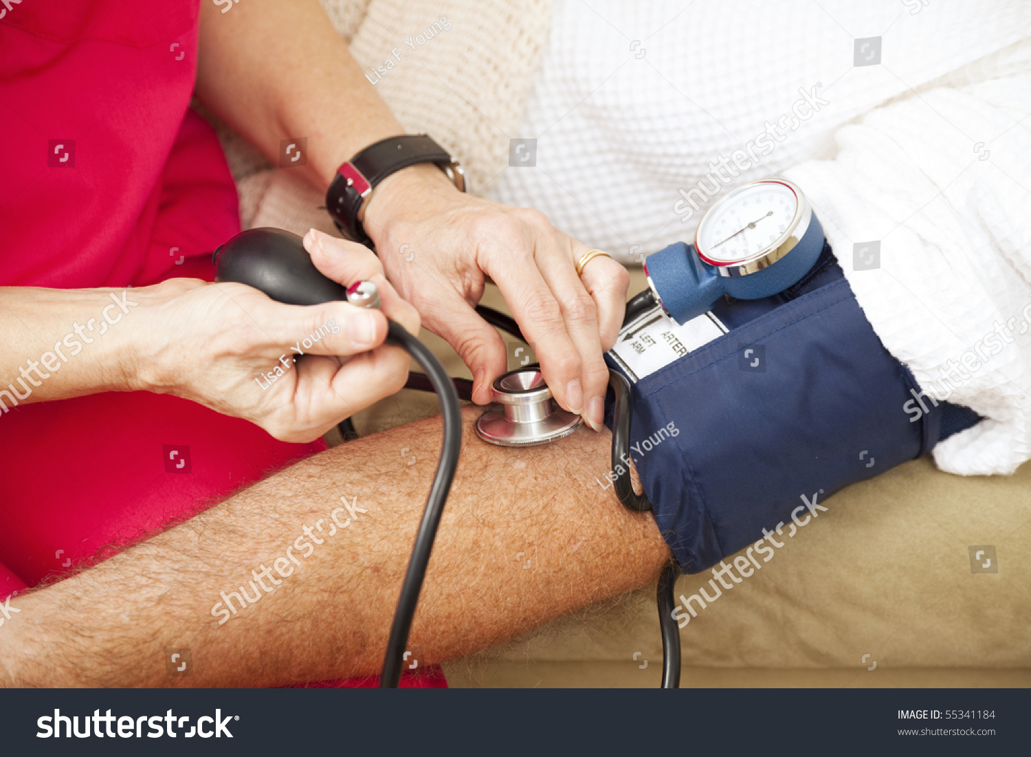 Nurse Taking A Patients Blood Pressure Using A Sphygmomanometer