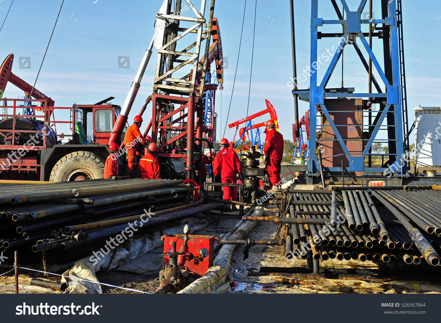 oil-field-oil-workers-at-work-stock-photo-526567864-shutterstock