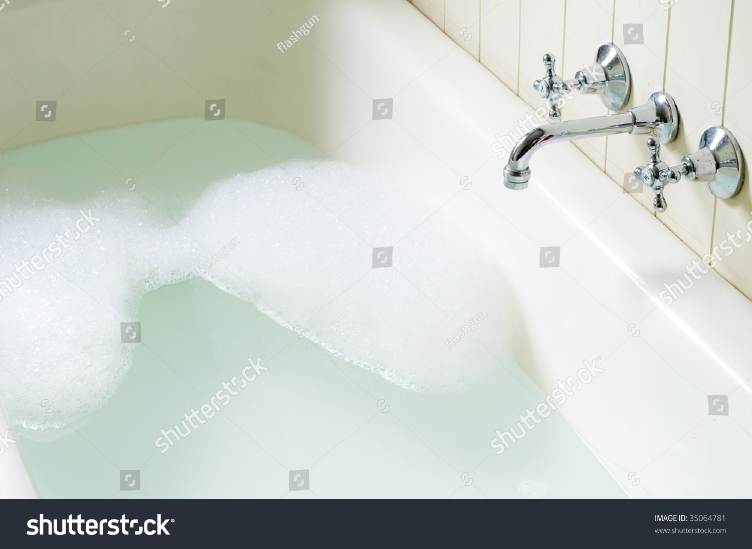 Old Bath Tube With Bubbles Water And Hot And Cold Tap