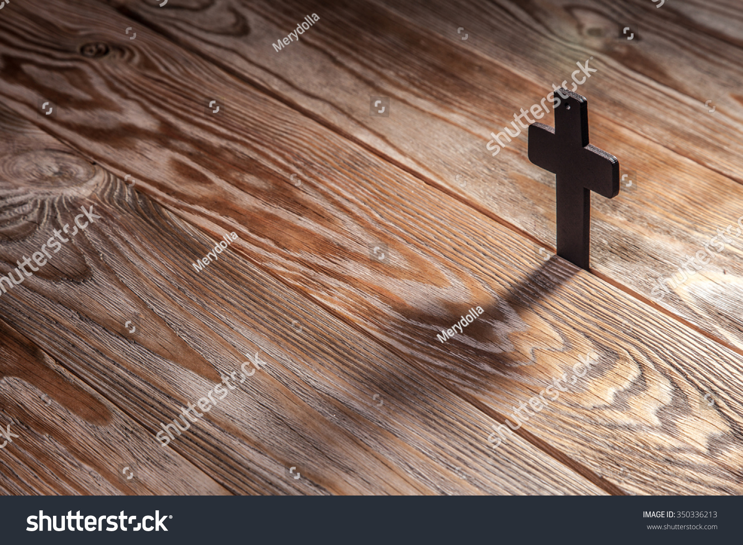 Old cross on a brown wood background Old cross on a brown wood background