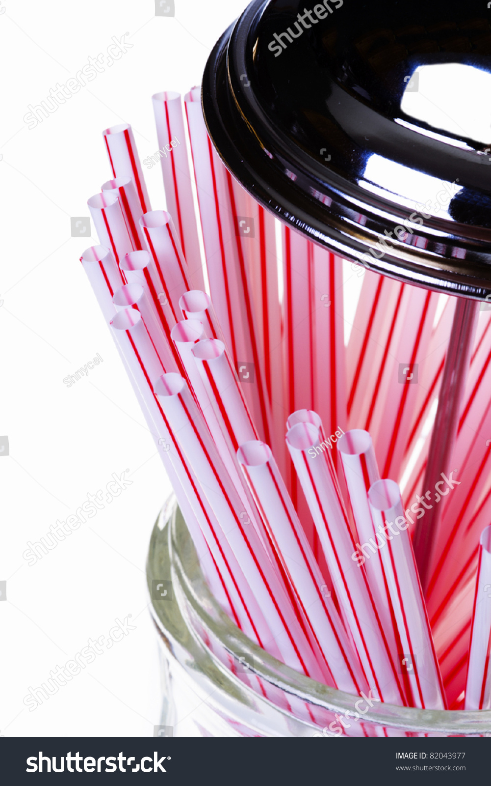 OldFashioned Straw Dispenser With Red And White Striped Straws Stock