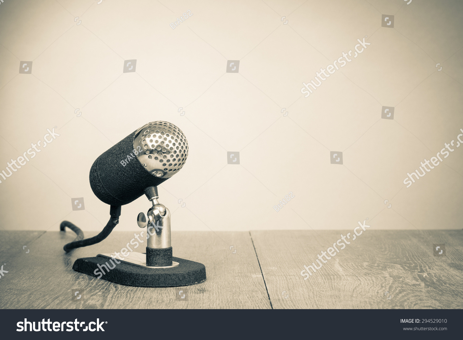 Old Retro Microphone From 50s On Table Vintage Style Sepia Photo