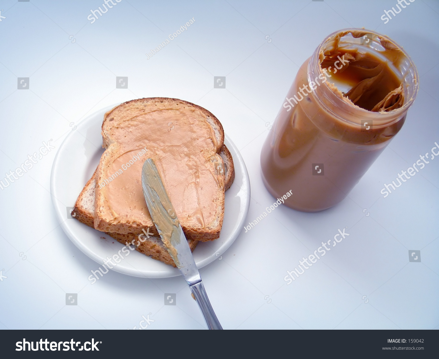 Peanut Butter Being Spread Onto A Slice Of Bread, With Peanut Butter