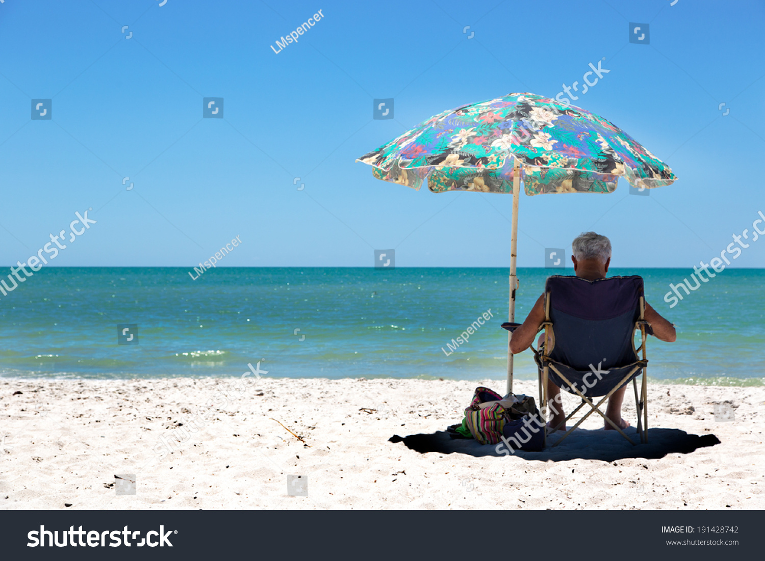 People In A Beach Umbrella Enjoying A Summer Day. Naples, Florida Stock 