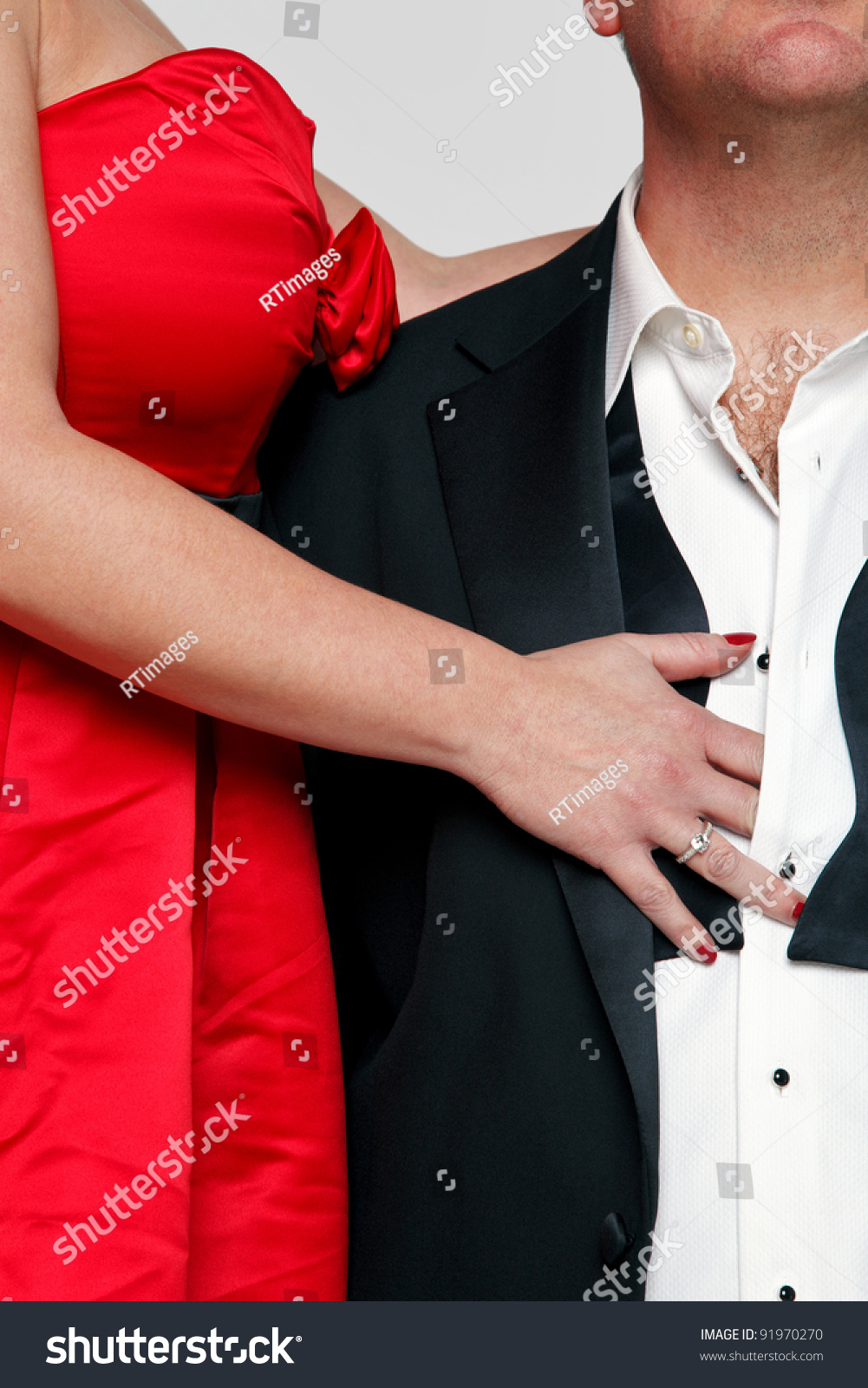 Photo Of A Woman In A Red Dress With Red Fingernails Unbuttoning The Shirt Of A Man Wearing A 9853