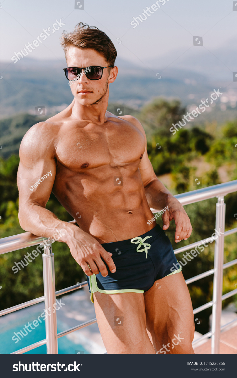 Photogenic Muscular Man Posing Outdoors Shirtless库存照片1745226866