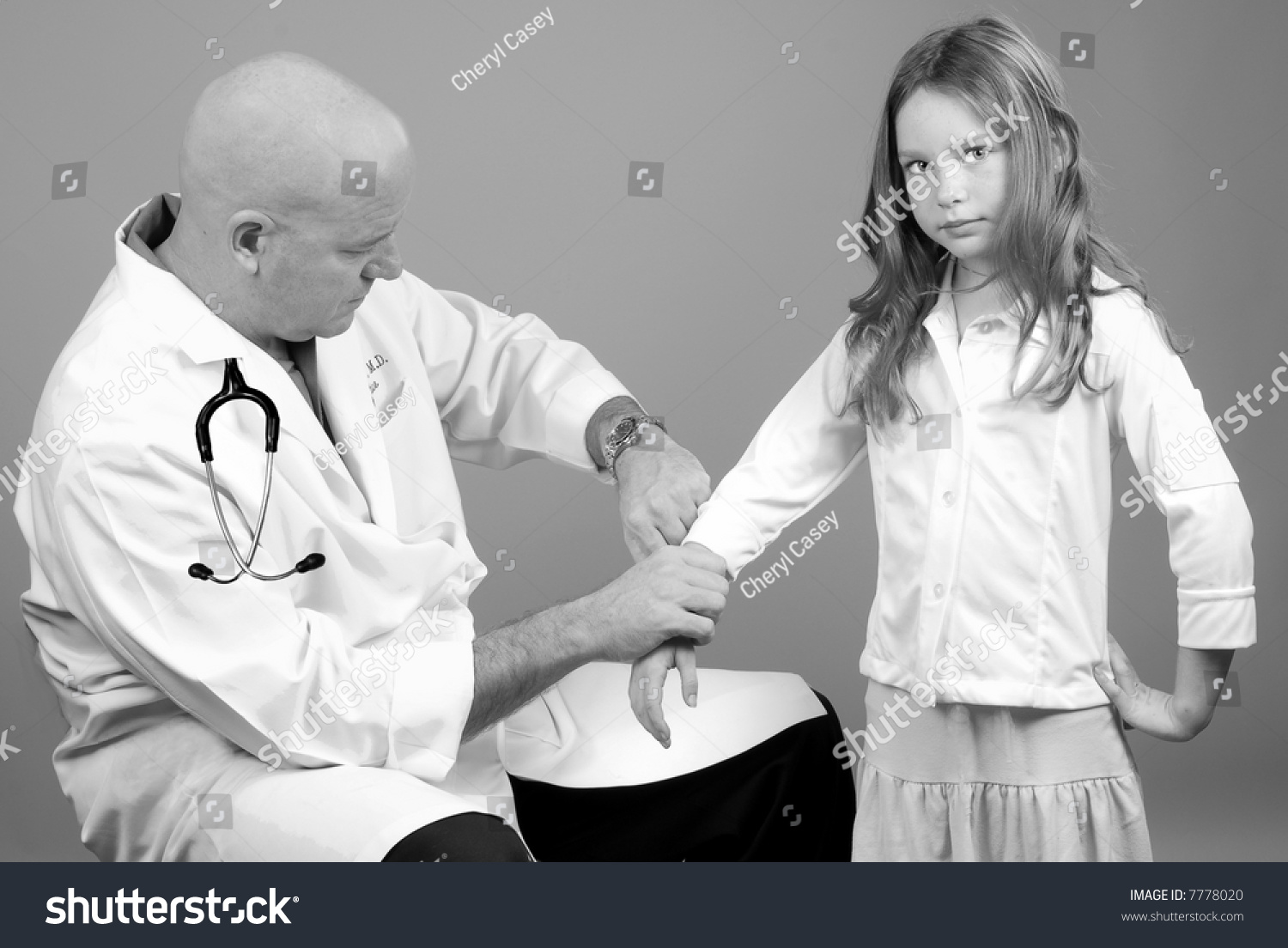 Physician Taking Girls Pulse During Physical Stock Photo 7778020