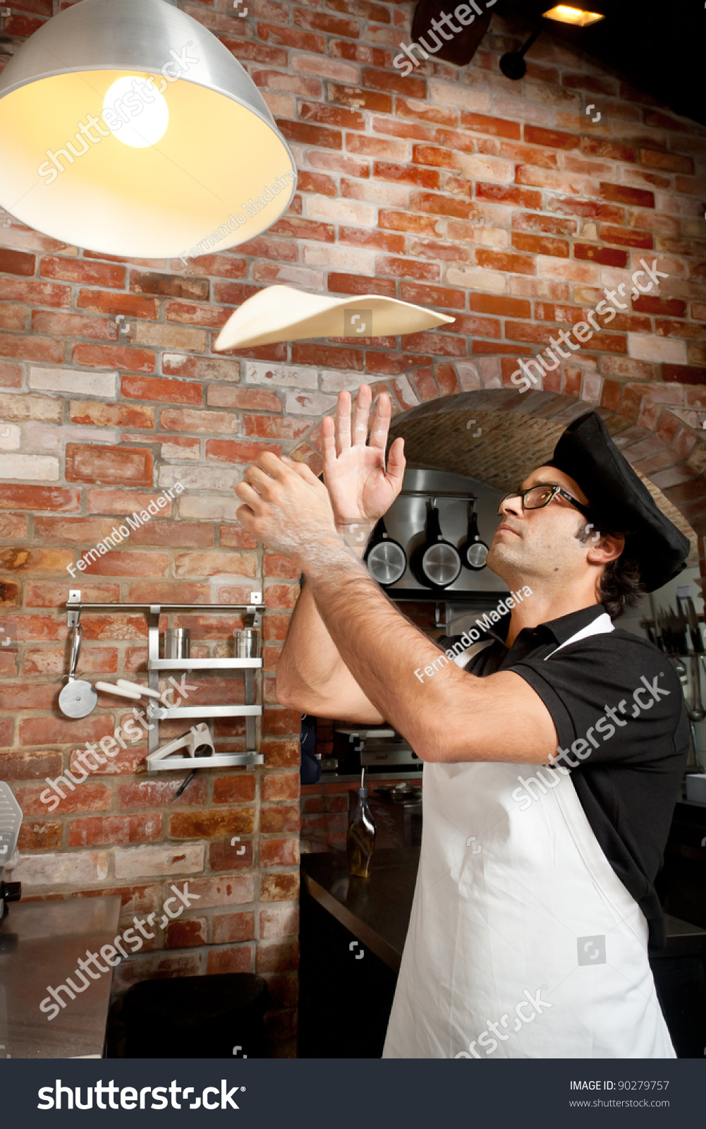 Pizza Chef Makes The Pizza Dough Spin In The Air To Make It Thin And