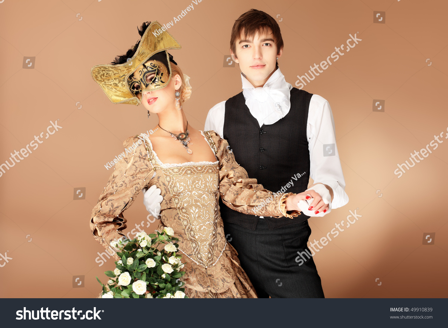 Portrait Of A Beautiful Couple In Medieval Era Costumes. Shot In A