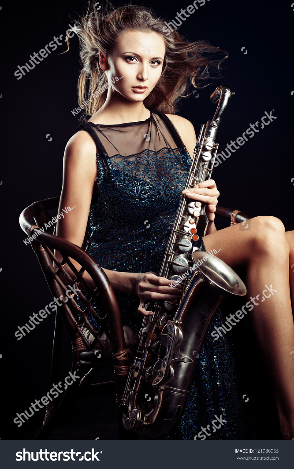 Portrait Of A Sexual Young Woman Posing With Saxophone At 