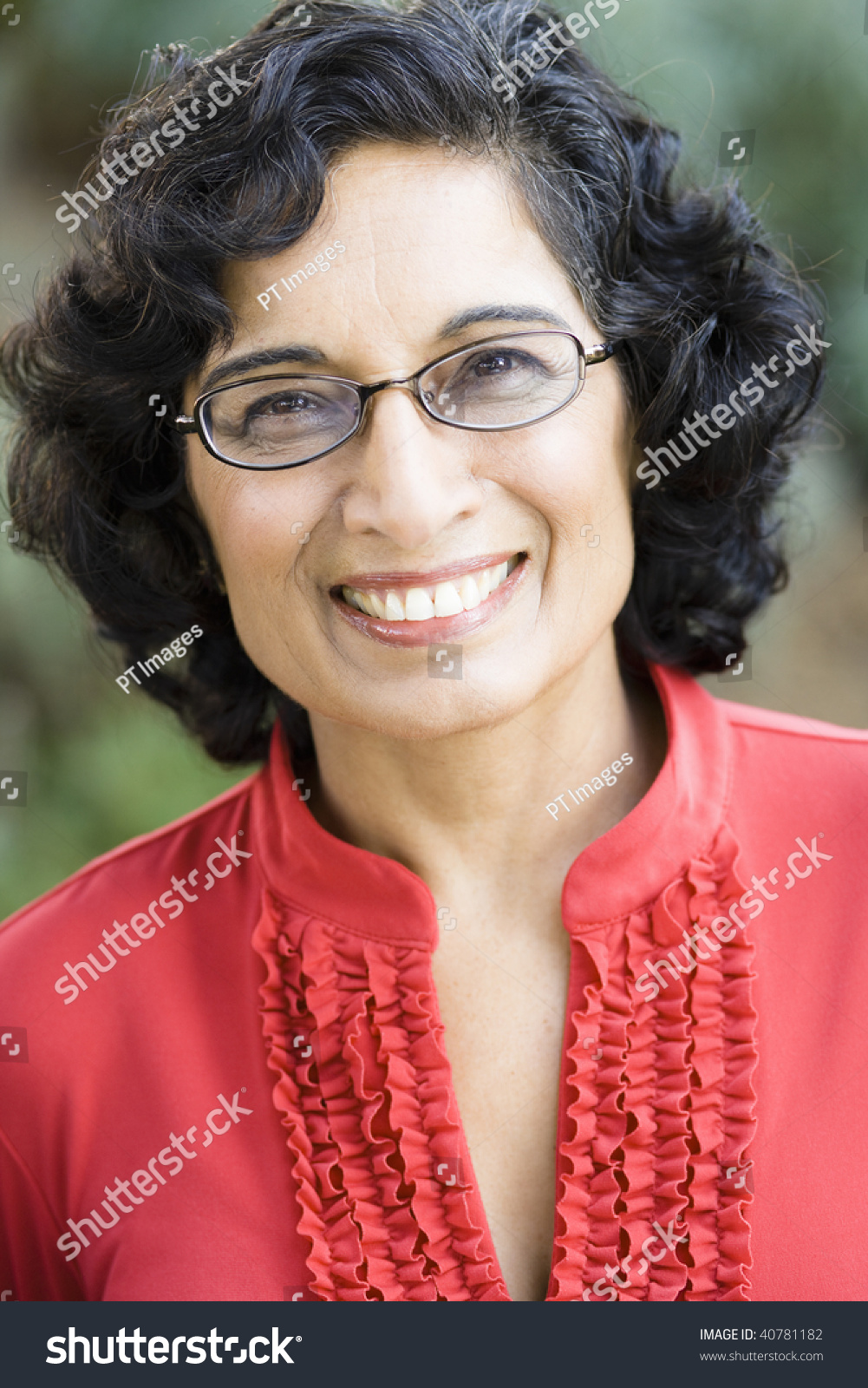 Portrait Of A Smiling Mature Indian Woman Looking Directly To Camera