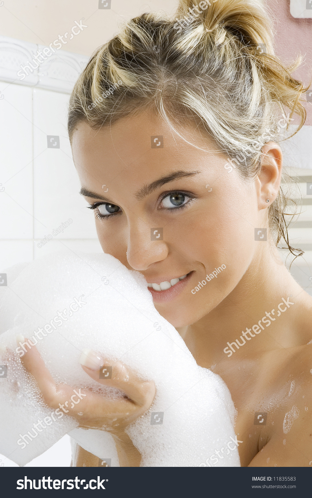 Portrait Of A Young And Cute Girl In Bathtub With Foam Near Her Face