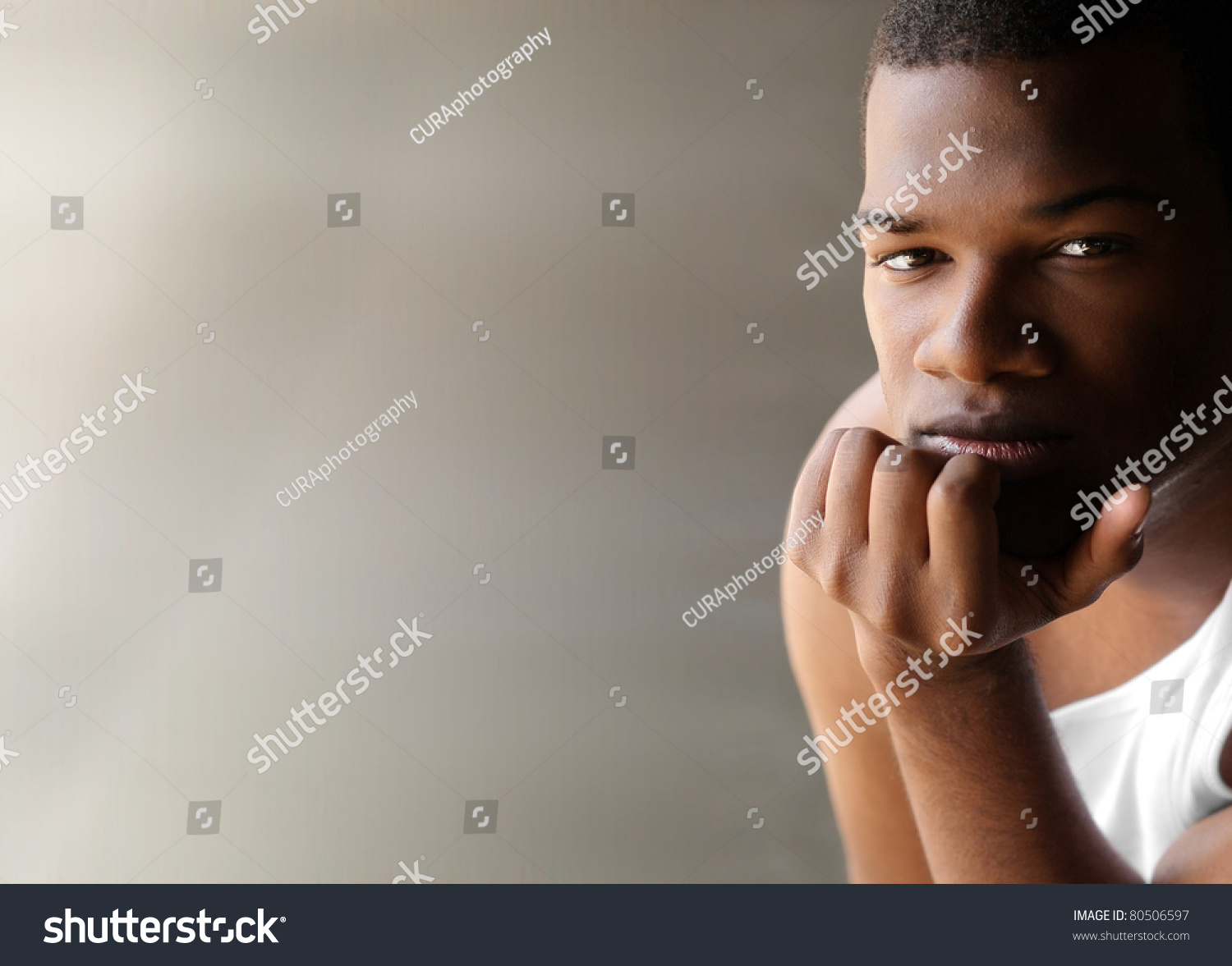 Portrait Of A Young Black Man Thinking Against Neutral Modern Background With Copy Space Stock