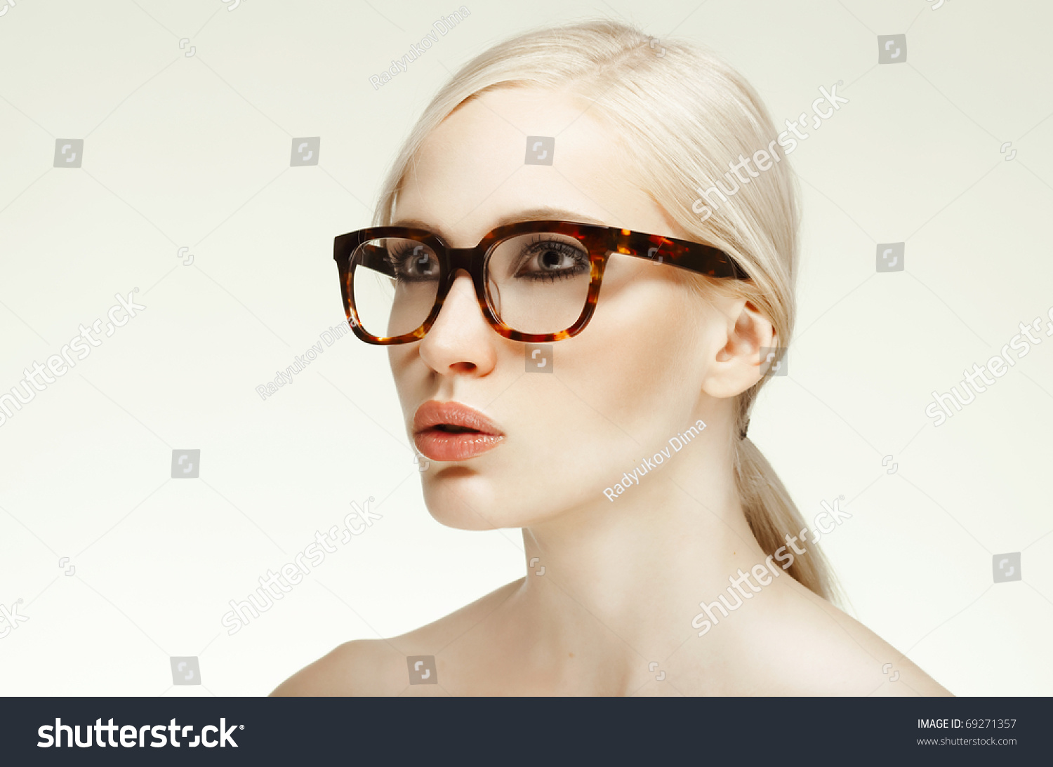 Portrait Of Beautiful Blond Woman In Glasses Posing On