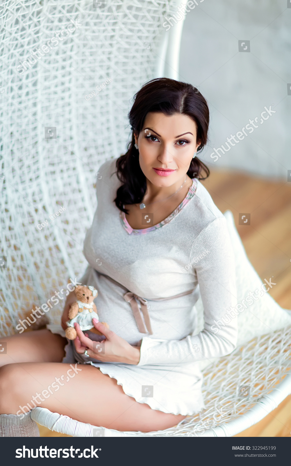 Portrait Of Beautiful Sexy Pregnant Brunette In A White