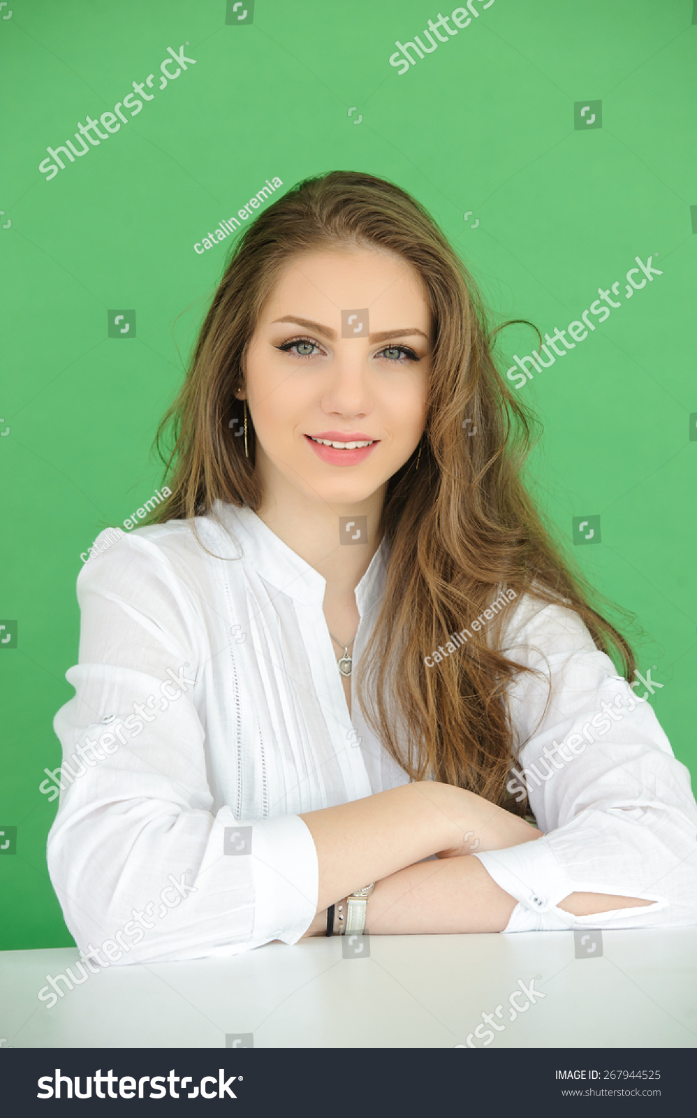 Portrait Of Beautiful Young Woman Over Green Screen Background Stock