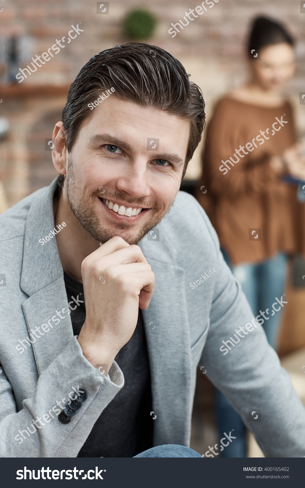 Save to a lightbox - stock-photo-portrait-of-confident-young-businessman-smiling-happy-hand-on-chin-400165402