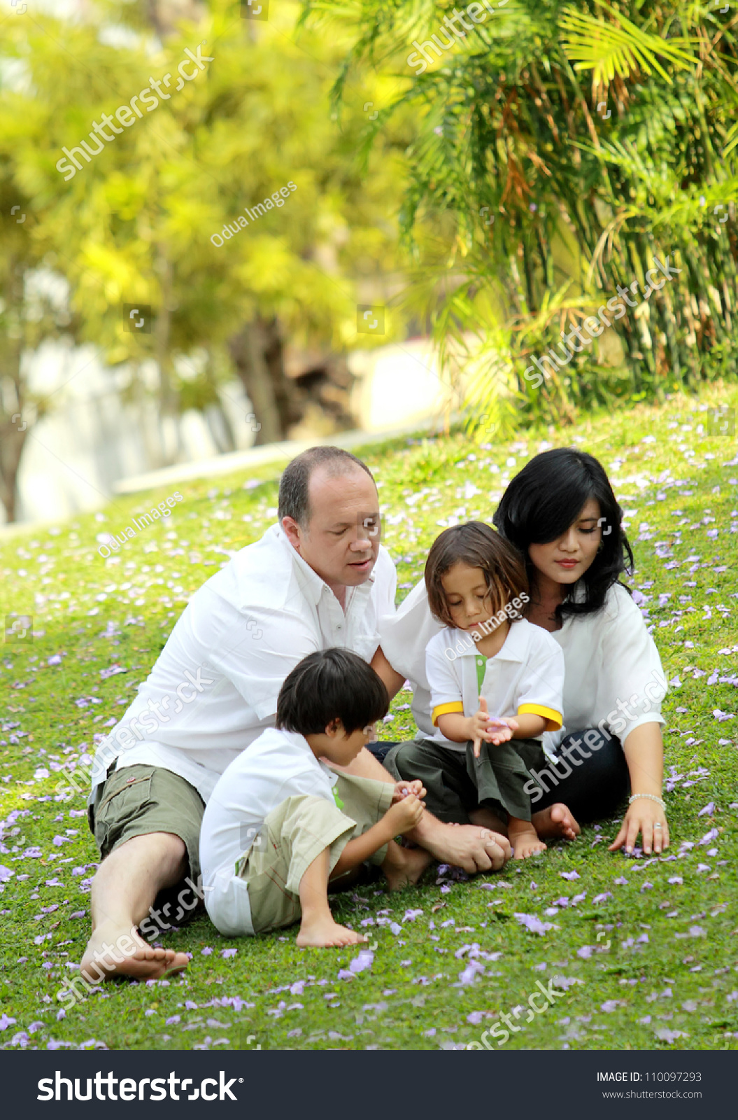 Caucasian Happy Family In The Park Portrait Of Happy Asian Caucasian Family In The Park Stock