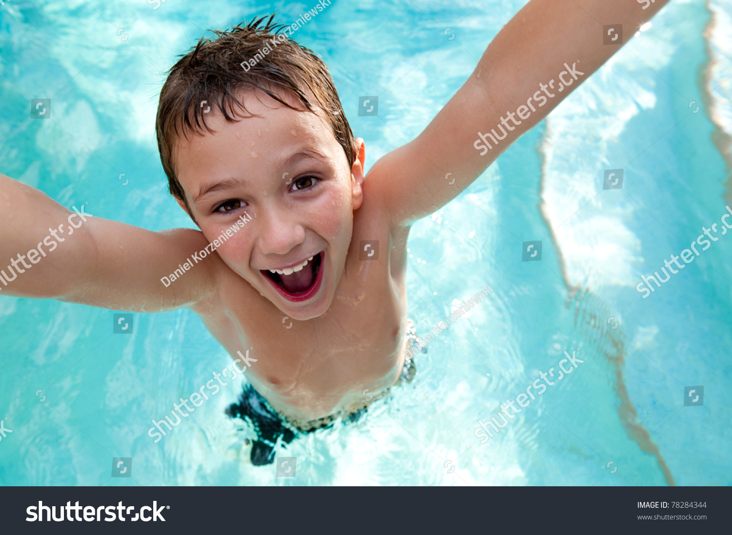 Portrait Of Kid Very Playful And Jumping In A Swimming Pool Stoc