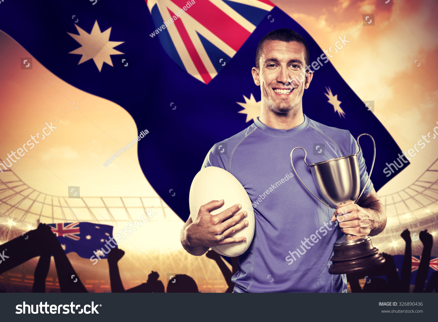 Portrait Smiling Rugby Player Holding Trophy Stock Photo