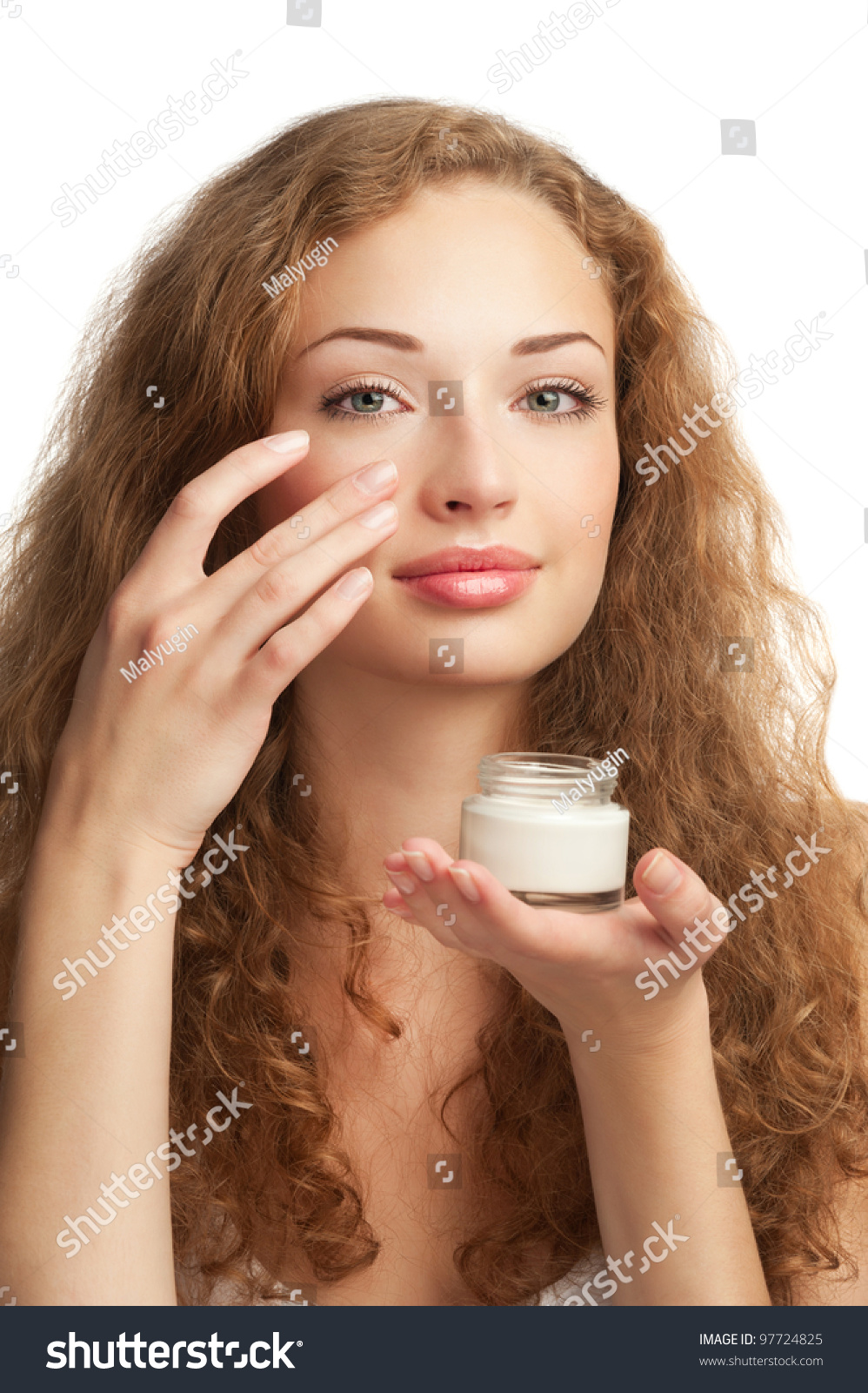 Portrait Of Young Beautiful Woman Applying Moisturizing Cream On Her