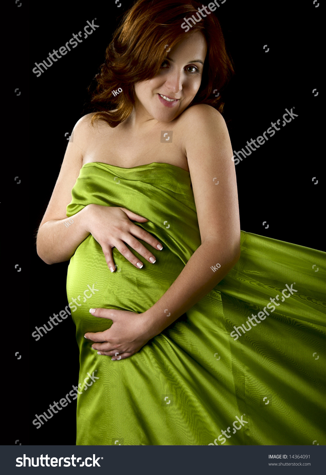 Pregnant Woman Posing On A Black Background With Beautiful Dress Stock