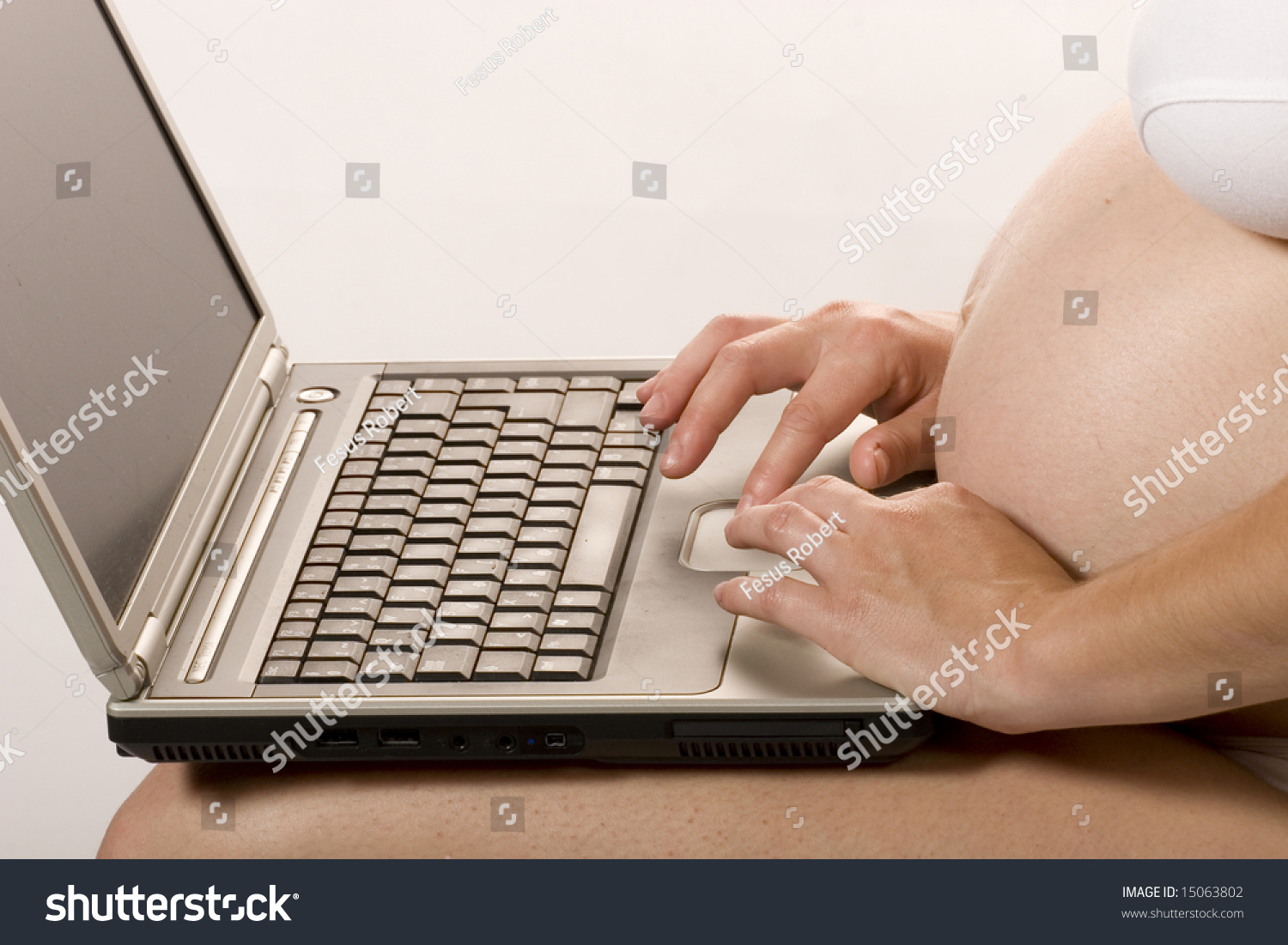 Pregnant woman working on a laptop Pregnant woman working on a laptop