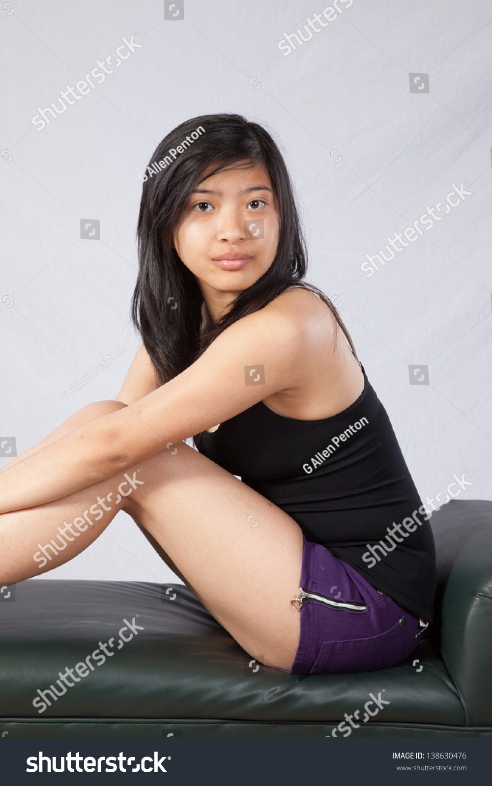 Pretty Asian Woman Sitting In Tank Top And Shorts Her
