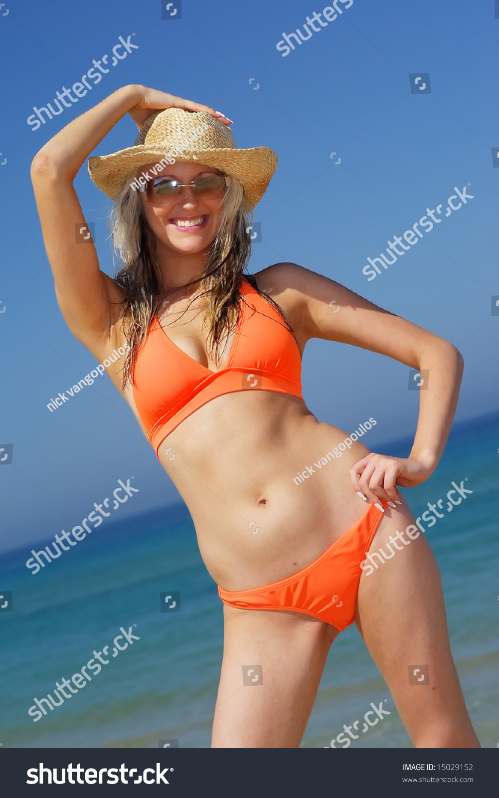 Pretty Blonde Model Posing In Orange Bikini Sunhat Stock Photo