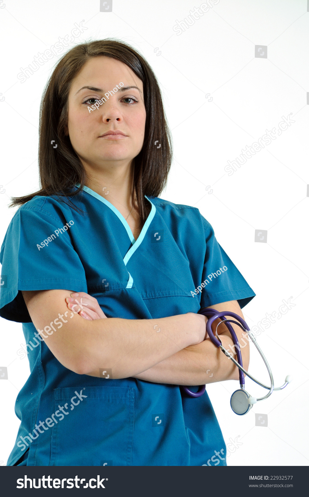 Pretty Female Nurse Or Doctor Holding Stethoscope Folded Arms Stern