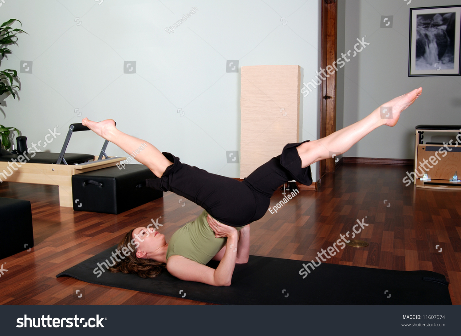 Pretty Young Pilates Instructor Performing Floor Excercise Stock Photo ...