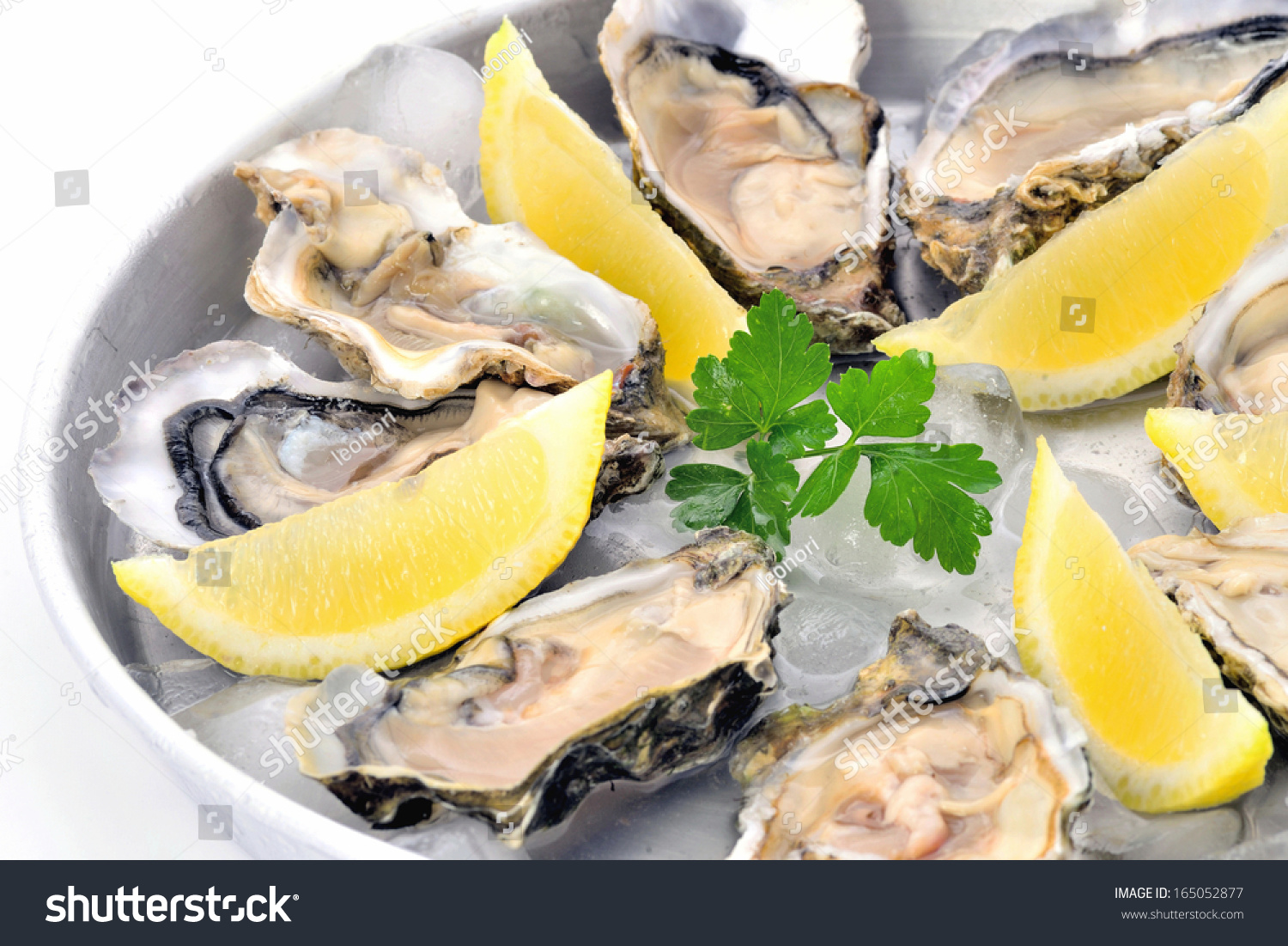 Raw Oysters Plate With Lemon On Ice Closeup, White Background.Fresh Raw ...